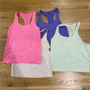 Lot of four waist length Lululemon run swiftly tanks size 8